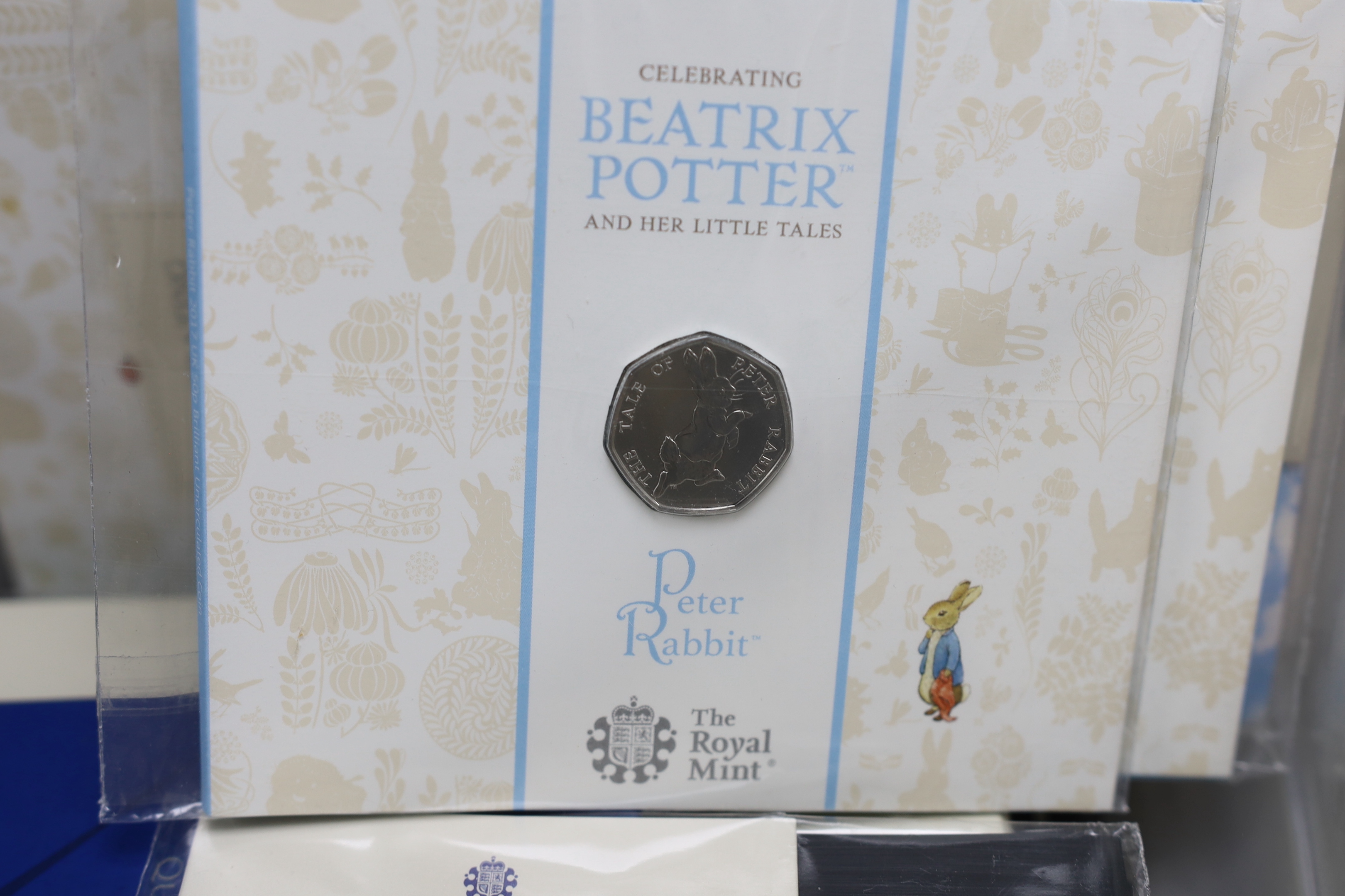 Royal Mint QEII and KCIII BUNC coins, including Beatrix potter 50p coins, Royal shield of arms 2008 year set, Queens reign and platinum jubilee £5, HM King Charles III, 1948 and 2020 3UK coinage collection etc.